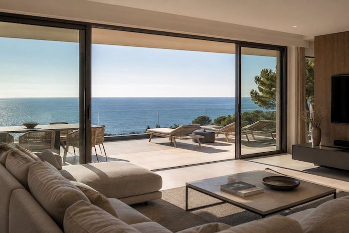 Maison avec vue mer dans le Var : quels critères augmentent réellement sa valeur ? Séjour lumineux avec grande baie vitrée offrant une vue panoramique sur la mer Méditerranée depuis une villa dans le Var.